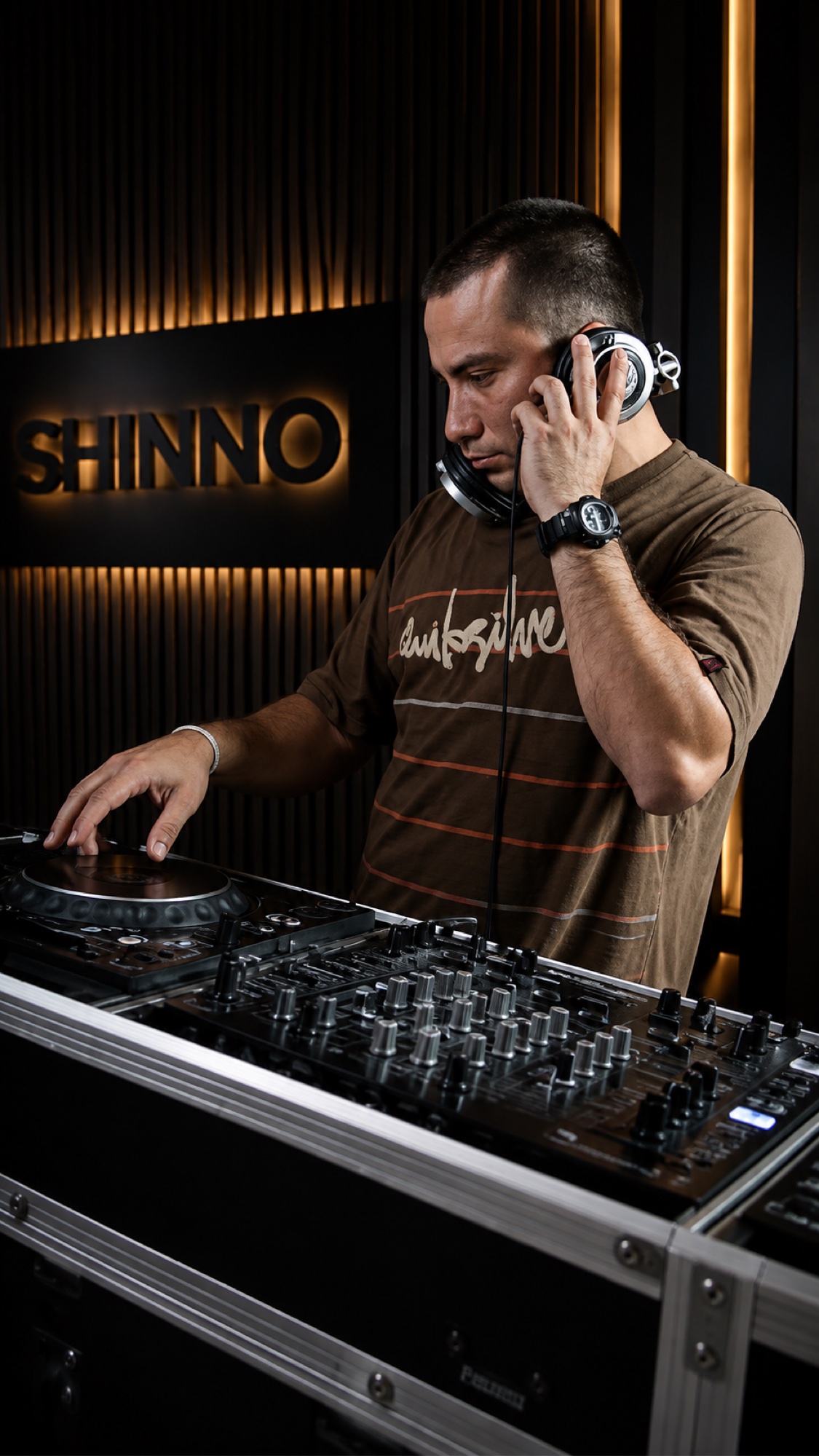 SHINNO at DJ equipment with a SHINNO sign