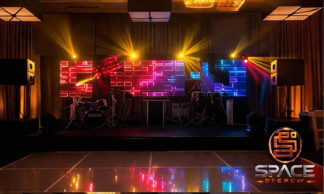 Event stage with LED cube wall and golden moving heads
