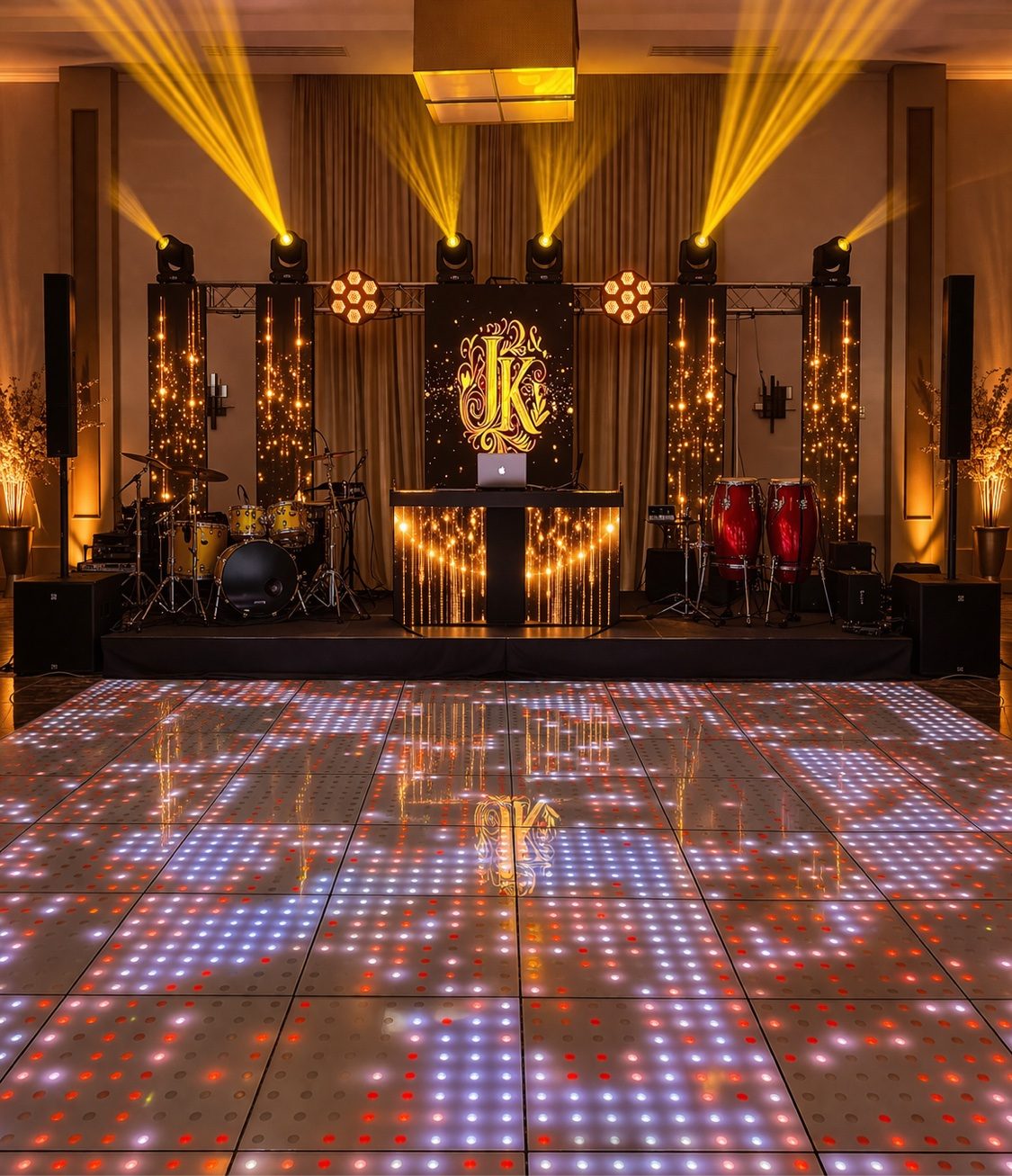 DJ booth with gold monogram LED screen and LED dance floor