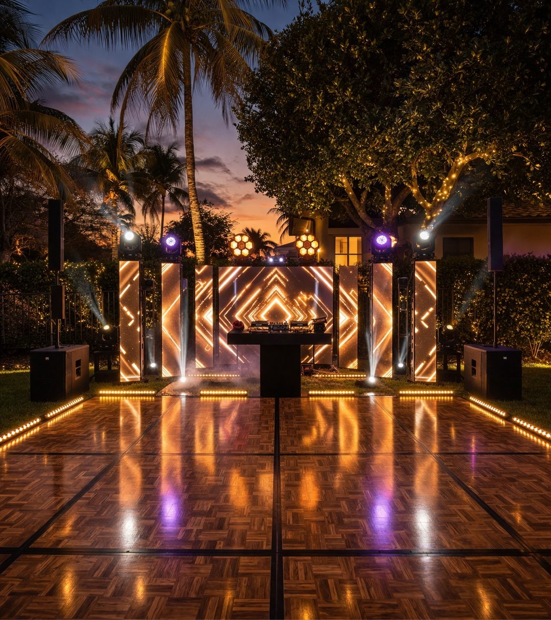 Outdoor sunset DJ setup with illuminated LED panels