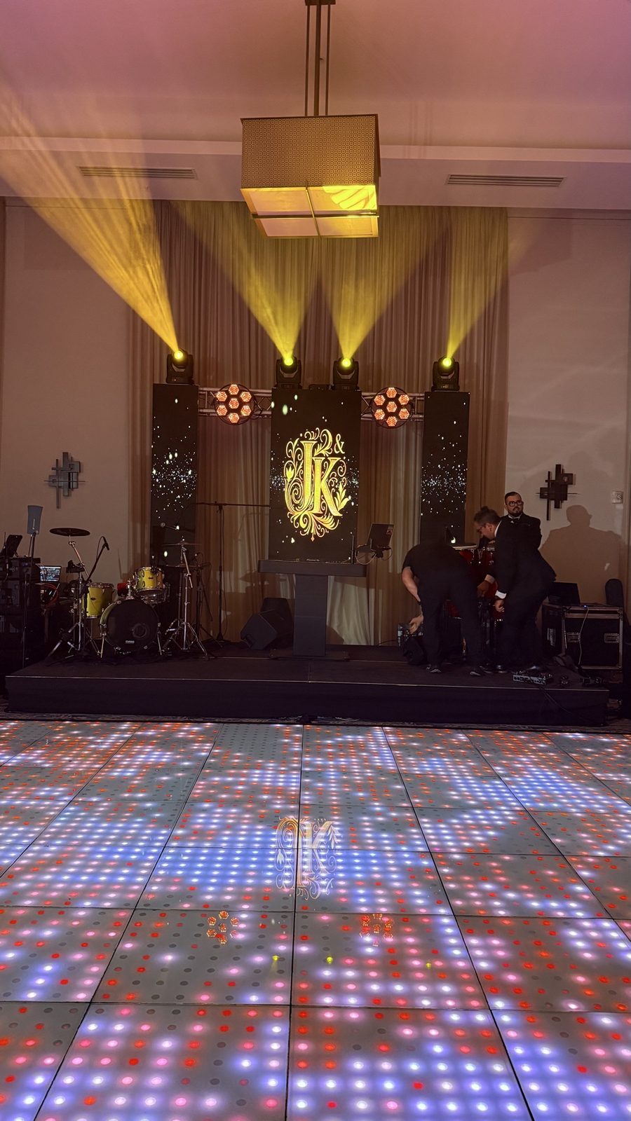 Wedding DJ booth with gold monogram LED and LED dance floor