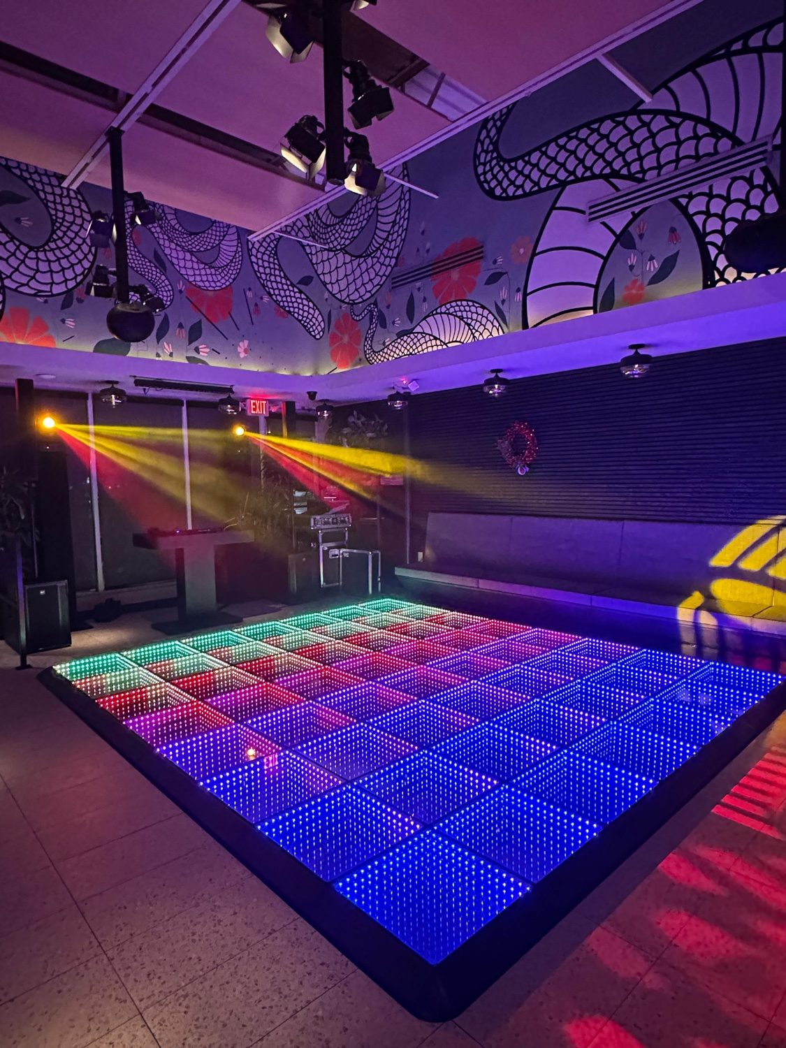 Club venue with LED infinity dance floor and mural art