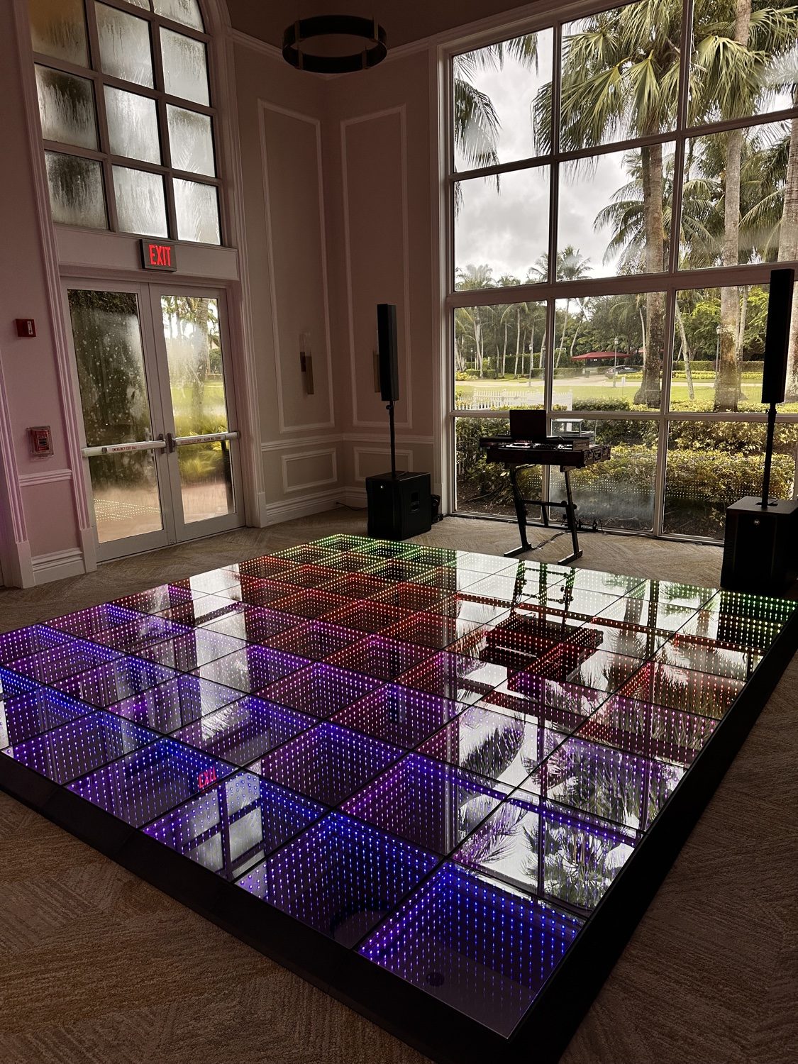 LED infinity dance floor room with DJ setup