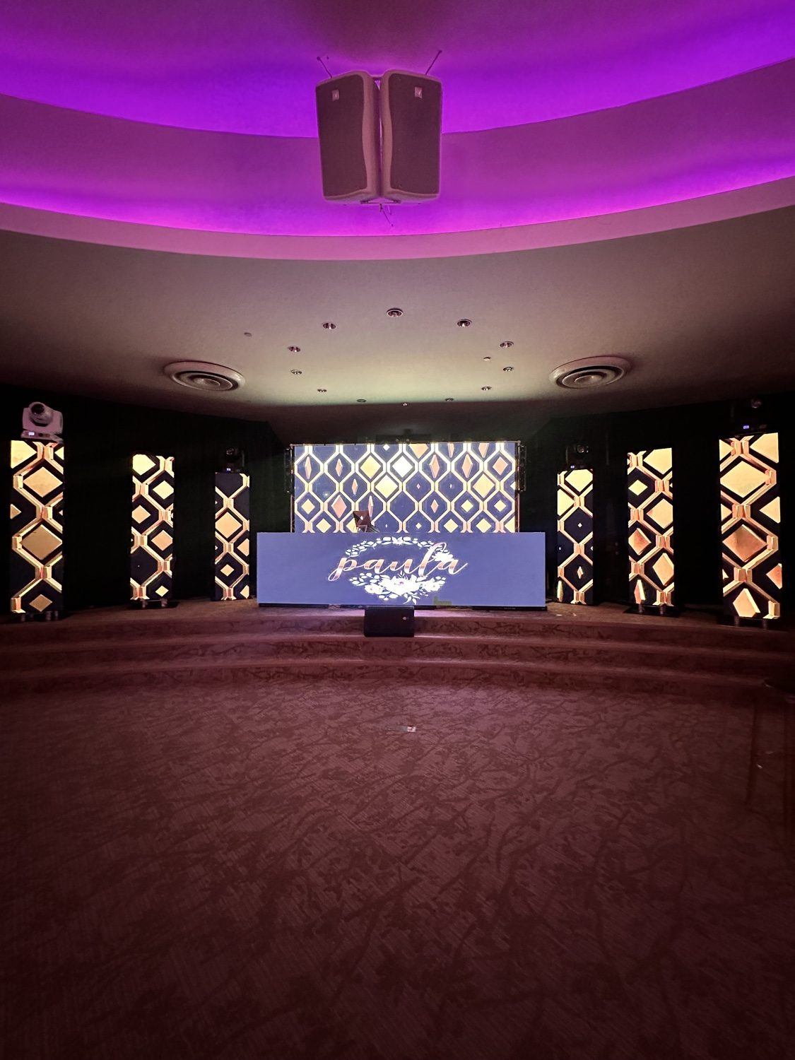 Quinceañera stage with purple and gold LED design