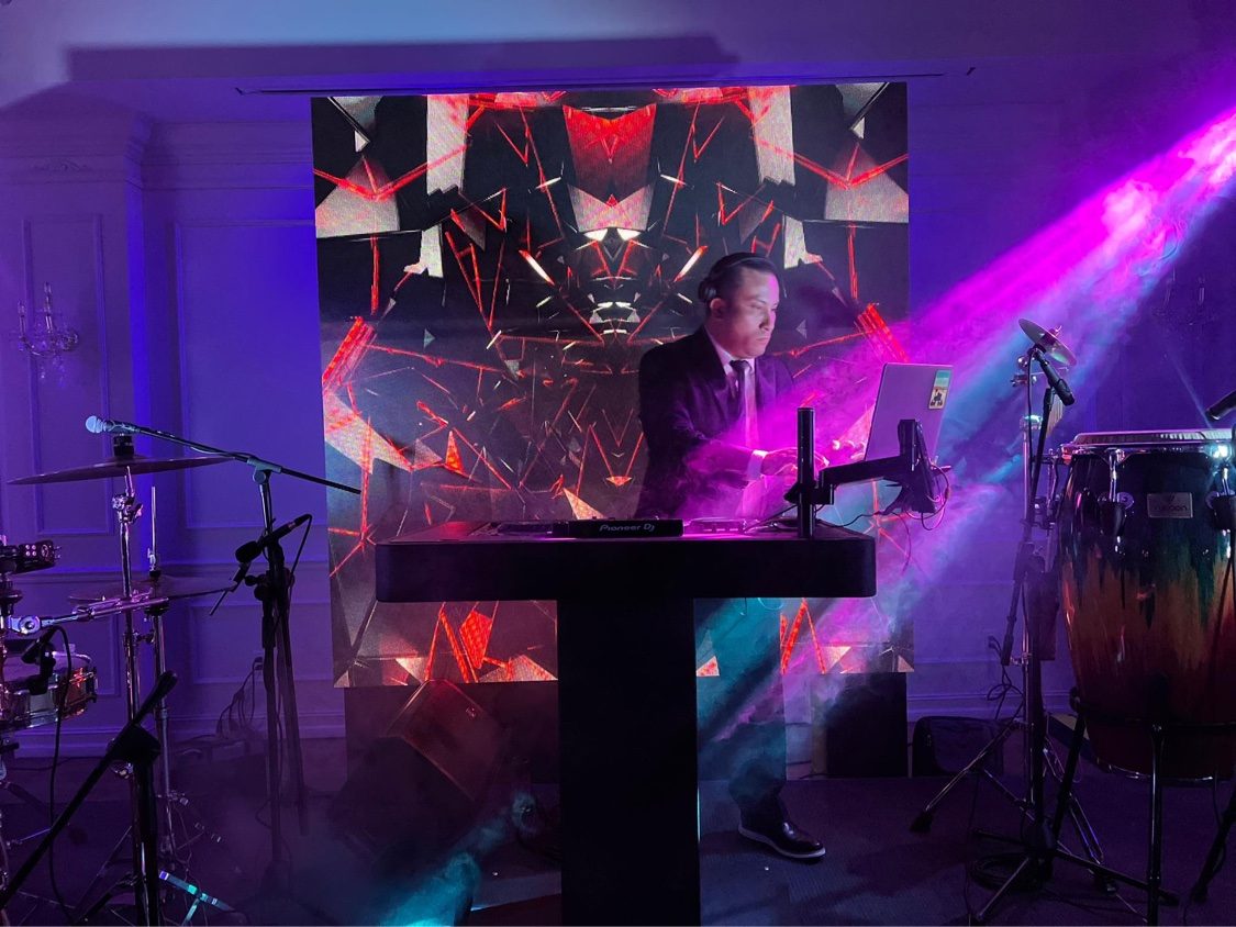 SHINNO performing with red geometric LED visuals and congas