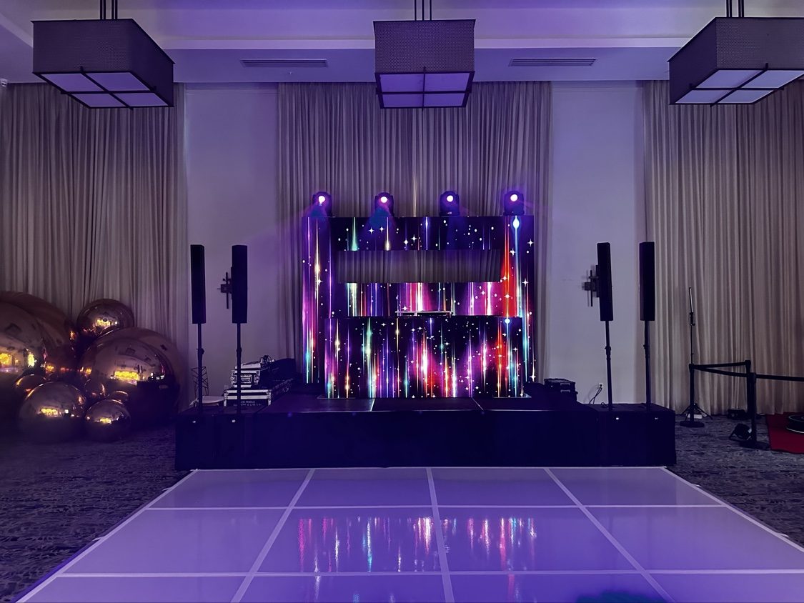 DJ booth with colorful light-streak LED wall