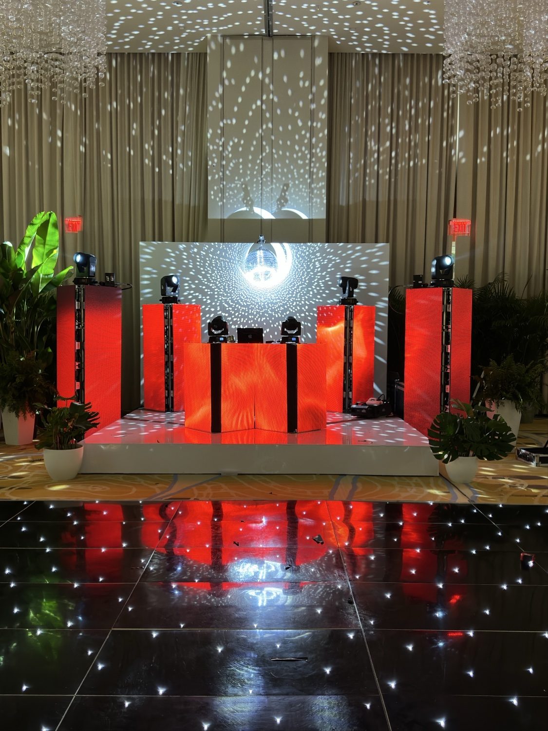 Red LED DJ booth with disco ball and starlit floor