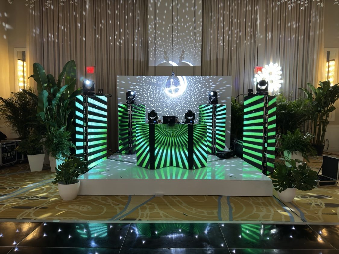 Green LED DJ booth with disco ball and starlit floor