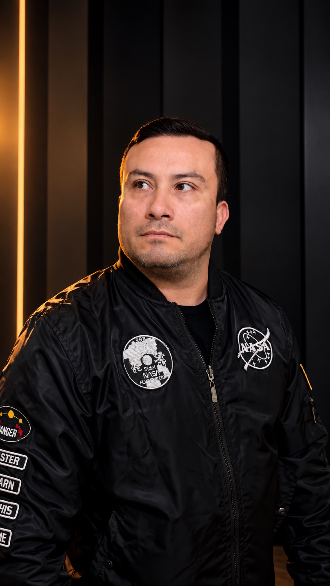 SHINNO in a black studio portrait