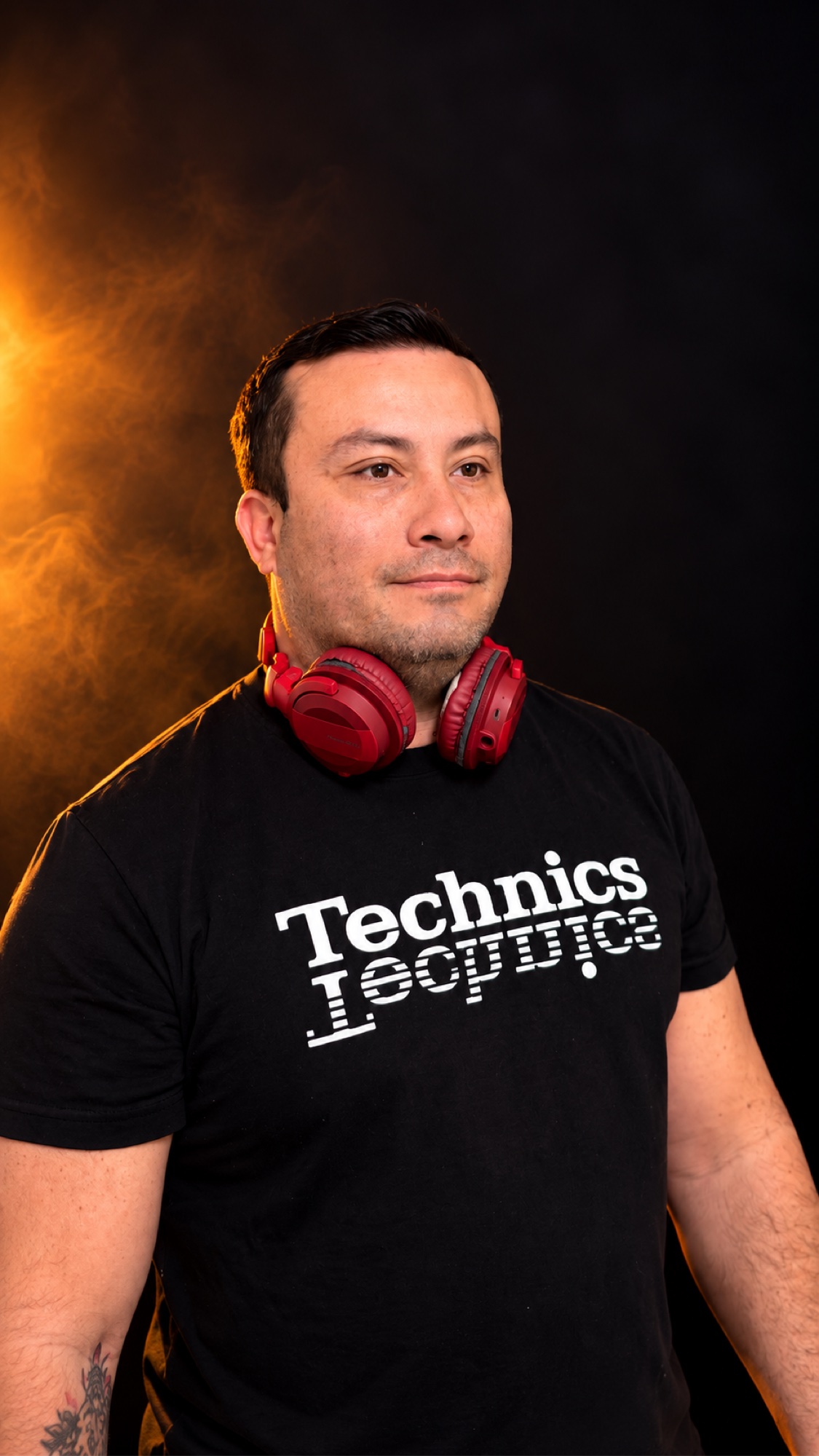 SHINNO in a red-lit studio portrait