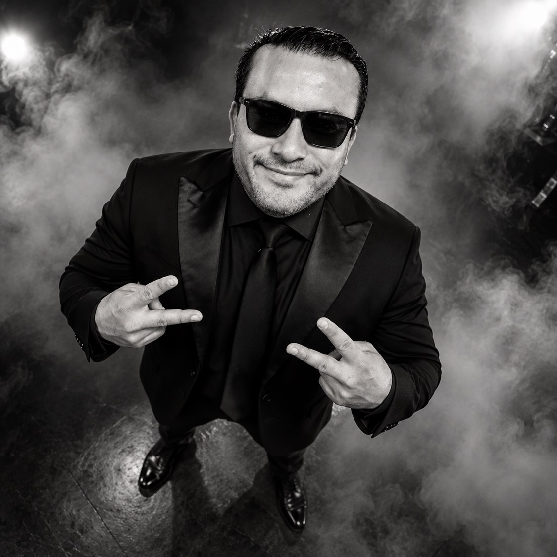 Black and white portrait of SHINNO in a suit