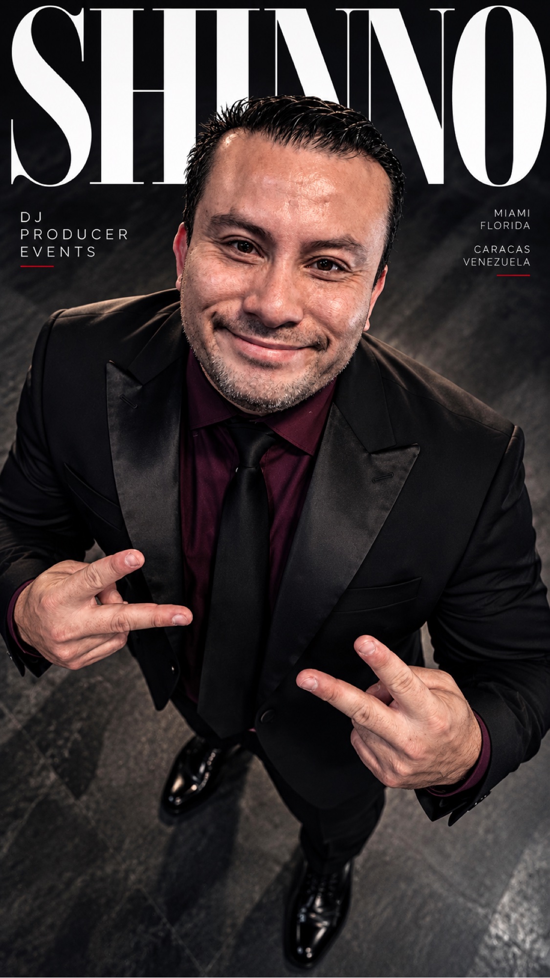 SHINNO smiling in a black suit